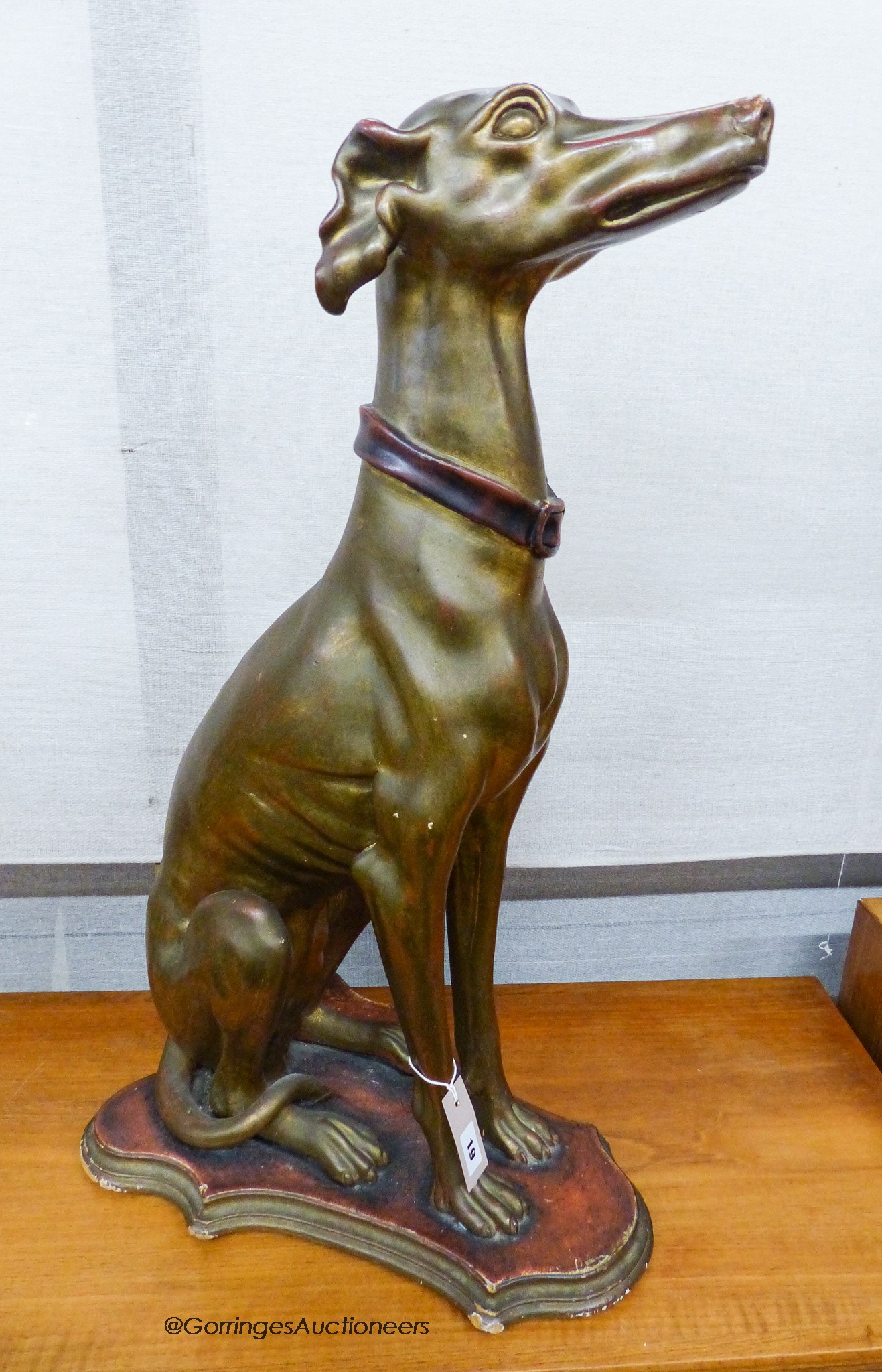 A gilt composition seated greyhound, height 78cm